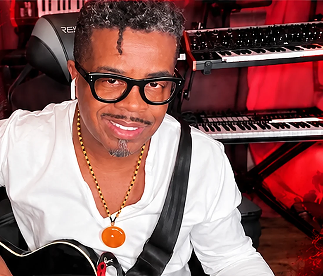 Stone Paxton, founder of Brand Artist Coalition, in the studio with his guitar